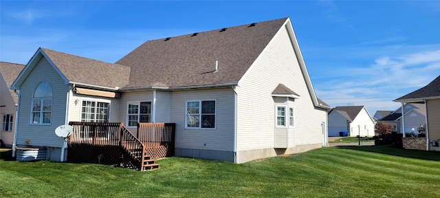 back of property with a lawn and a wooden deck