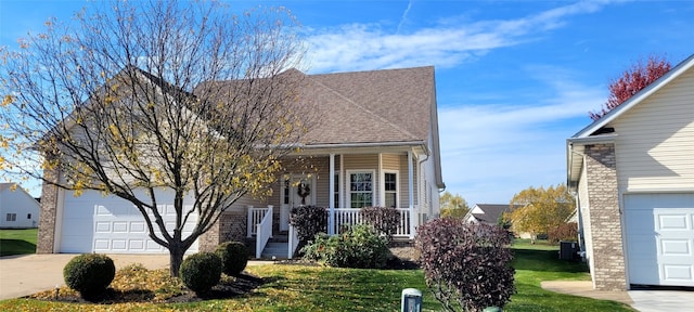 view of front facade with a porch, a garage, and a front lawn