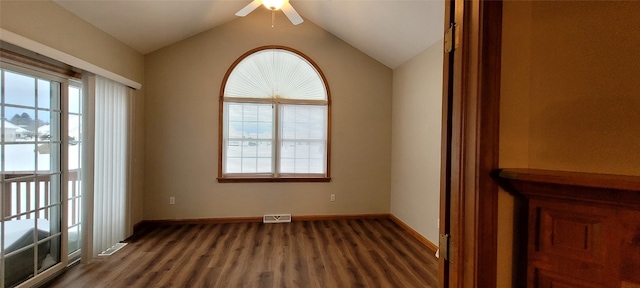 spare room featuring vaulted ceiling, ceiling fan, and dark wood-type flooring