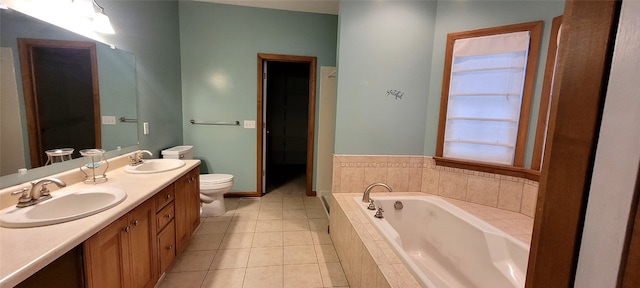 bathroom featuring tile patterned floors, vanity, a relaxing tiled tub, and toilet