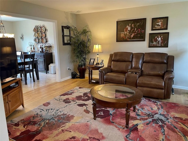 living room featuring light wood-type flooring and baseboards