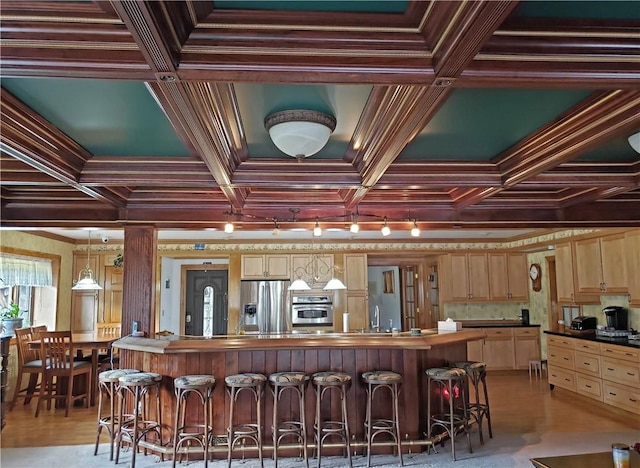 kitchen with pendant lighting, crown molding, and appliances with stainless steel finishes