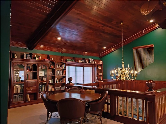 dining area with beam ceiling and an inviting chandelier