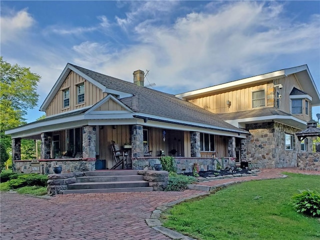 view of front of house with a front yard and a porch