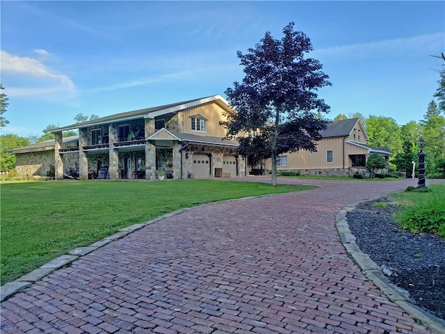 view of front of home with a garage and a front lawn