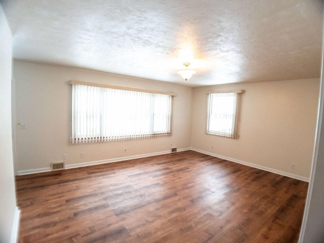 unfurnished room featuring dark wood-type flooring