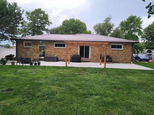 back of property with a patio area and a lawn