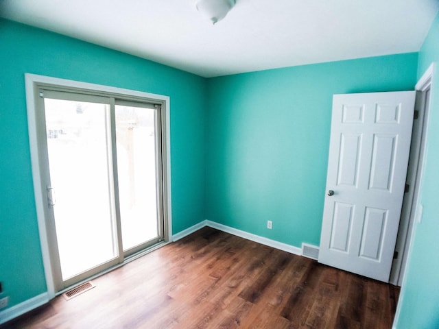 empty room with dark hardwood / wood-style floors