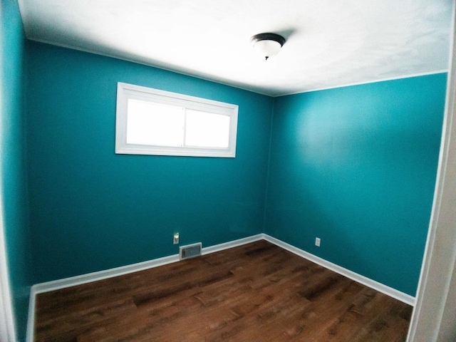 empty room with dark hardwood / wood-style floors