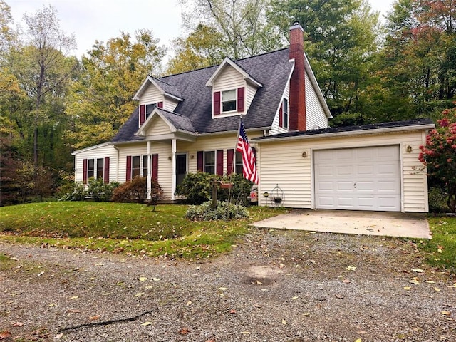 cape cod house featuring a garage and a front lawn