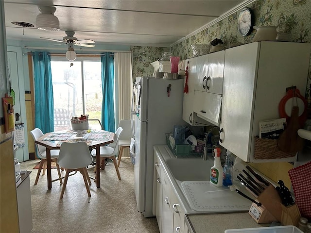 kitchen featuring ceiling fan, white cabinets, and white fridge