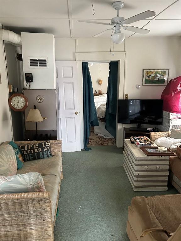 living room with ceiling fan and carpet floors