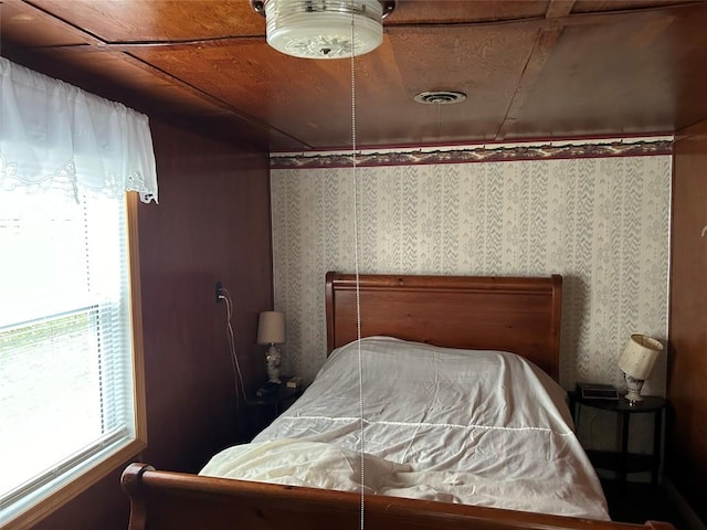 bedroom with multiple windows and wood ceiling