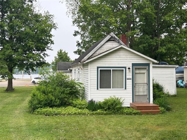 12656 Comstock St, Conneaut Lake, PA 16316 - view of front of property featuring a front lawn and a chimney