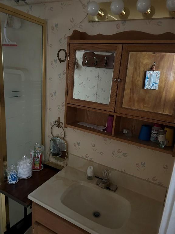 12656 Comstock St, Conneaut Lake, PA 16316 - bathroom with wallpapered walls and vanity