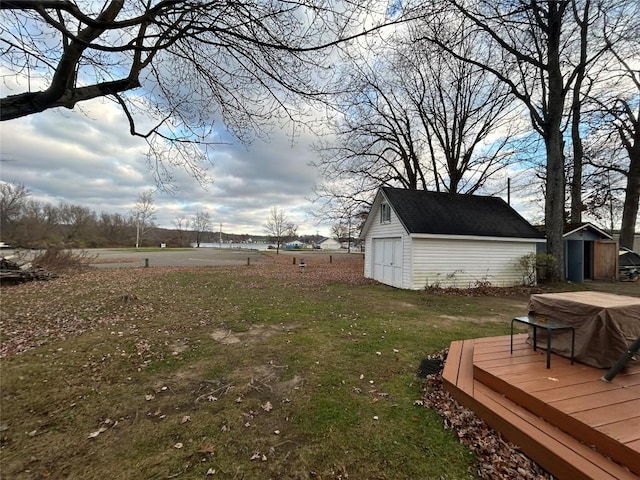 view of yard featuring a deck and a storage unit