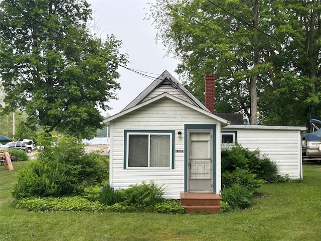 12656 Comstock St, Conneaut Lake, PA 16316 - view of front of house featuring a front lawn and a chimney