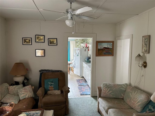 carpeted living room with ceiling fan