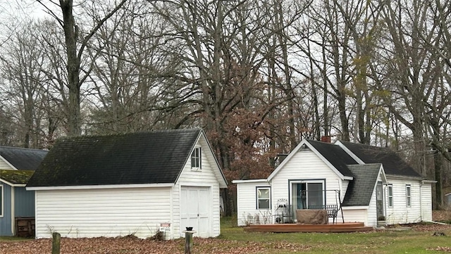 view of property exterior with a shed, a deck, and a lawn