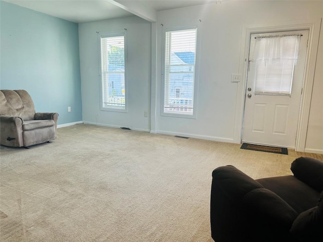 sitting room featuring light colored carpet