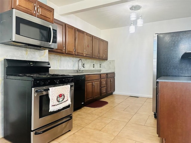 kitchen with backsplash, sink, light tile patterned floors, and stainless steel appliances