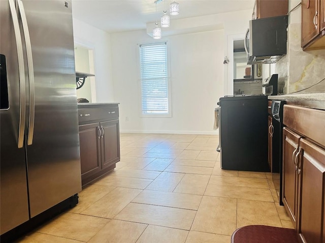 kitchen featuring decorative backsplash, dark brown cabinets, pendant lighting, stainless steel fridge with ice dispenser, and light tile patterned flooring