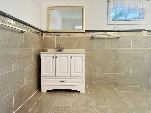 bathroom featuring vanity and tile walls