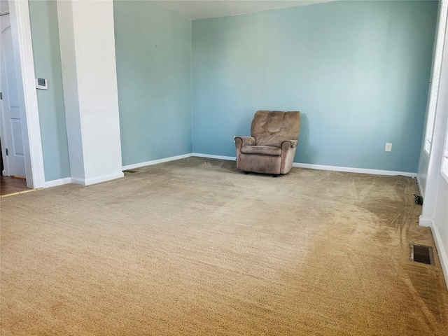 unfurnished room featuring light carpet