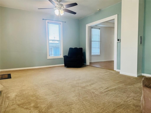 unfurnished room featuring ceiling fan and carpet