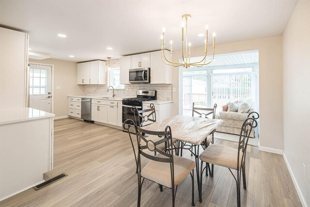 3411 Elmwood St, Erie, PA 16508 - dining space featuring light wood-type flooring, baseboards, a chandelier, and recessed lighting