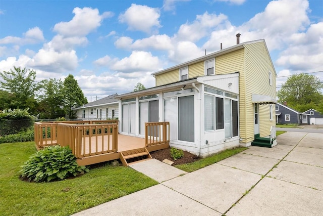 3411 Elmwood St, Erie, PA 16508 - rear view of house featuring a sunroom, a wooden deck, and a yard