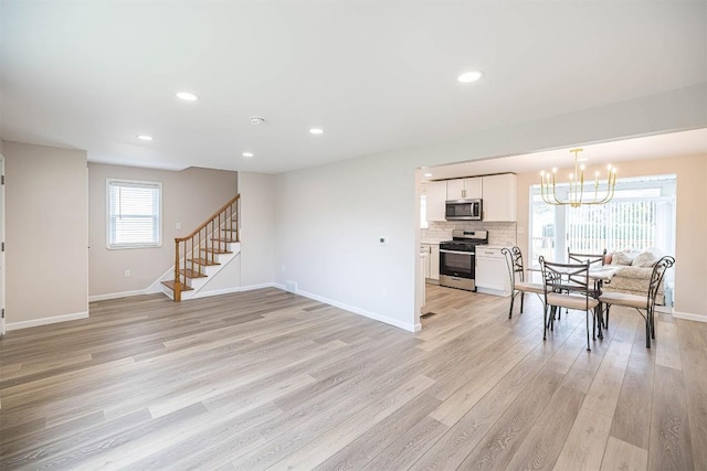 3411 Elmwood St, Erie, PA 16508 - dining room with light wood-style floors, baseboards, a chandelier, stairway, and recessed lighting