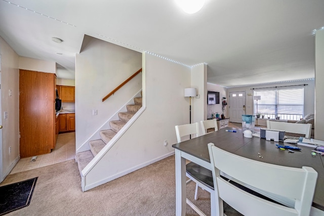 2521 Mccain Ave, Erie, PA 16510 - dining space with stairway, baseboards, and light carpet