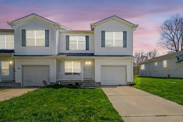 2521 Mccain Ave, Erie, PA 16510 - townhome / multi-family property with a garage, covered porch, a front yard, and concrete driveway