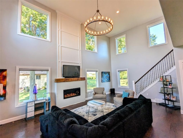 living room with a notable chandelier and a high ceiling