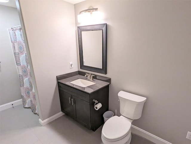 bathroom with tile patterned flooring, vanity, and toilet