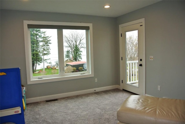 entryway featuring plenty of natural light and light colored carpet