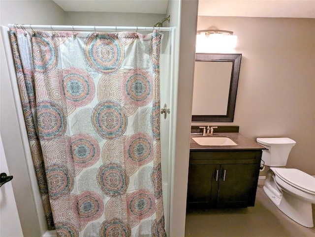 bathroom featuring vanity, toilet, and curtained shower