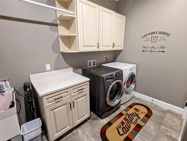 washroom with washer and dryer and cabinets