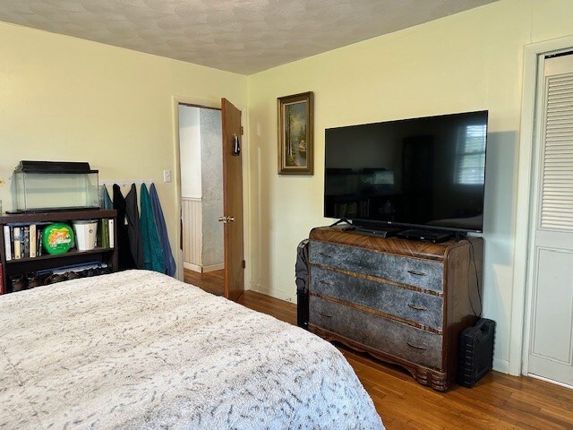 bedroom featuring baseboards and wood finished floors