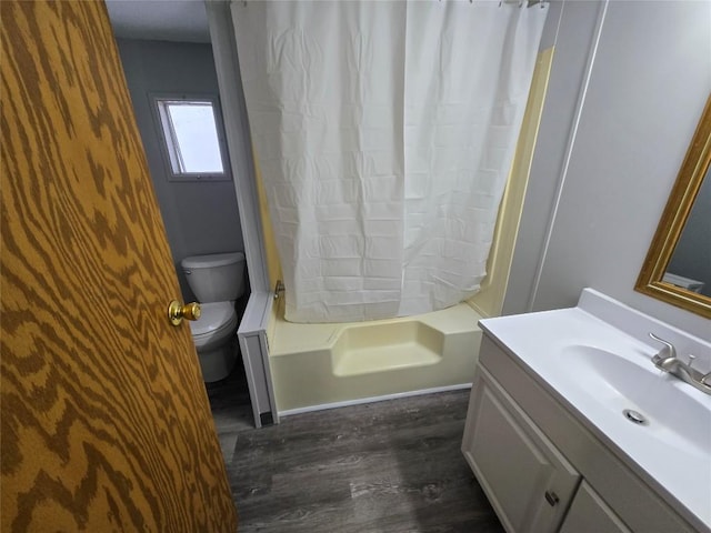 full bathroom featuring toilet, shower / bathtub combination with curtain, wood-type flooring, and vanity