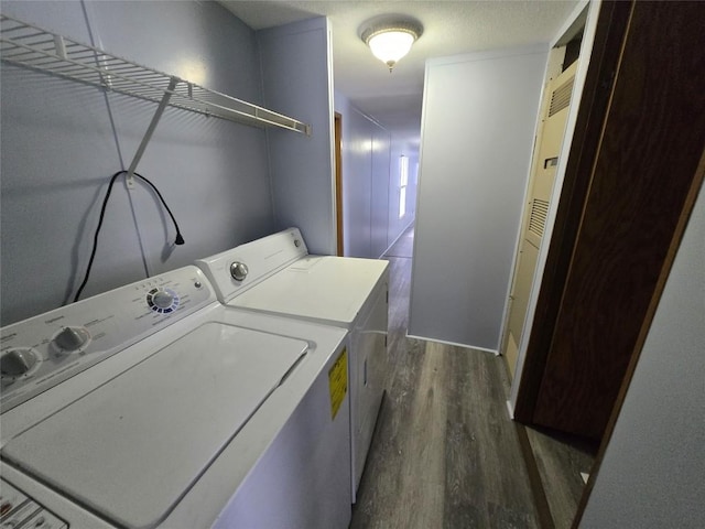 washroom featuring dark hardwood / wood-style floors and washing machine and clothes dryer