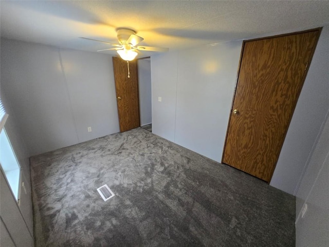 spare room featuring ceiling fan and carpet flooring