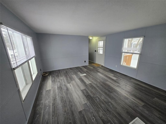 empty room featuring dark wood-type flooring