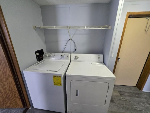 laundry area with dark hardwood / wood-style flooring and independent washer and dryer