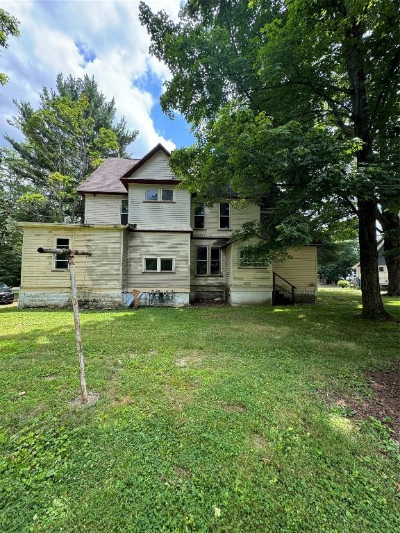 rear view of house with a yard