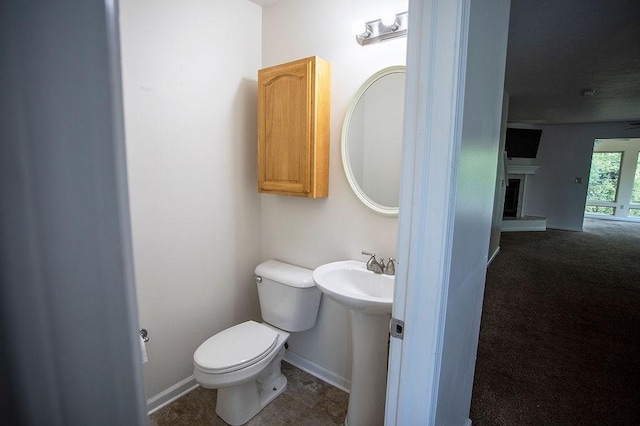 4165 Wood Hills Dr Unit C9, Erie, PA 16510 - half bathroom featuring toilet, a fireplace with raised hearth, and baseboards