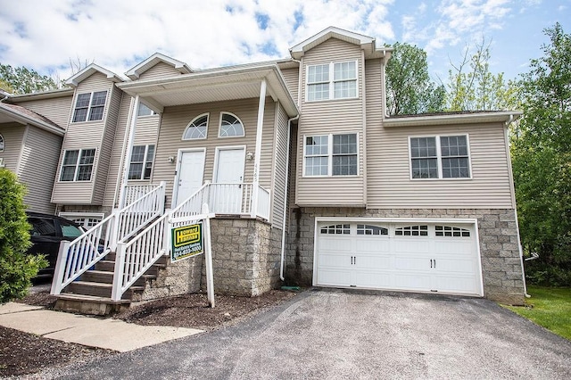 4165 Wood Hills Dr Unit C9, Erie, PA 16510 - view of front of property with an attached garage, asphalt driveway, and stone siding