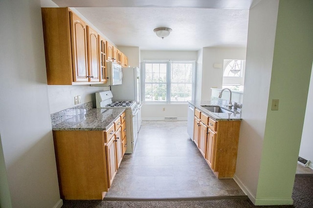 4165 Wood Hills Dr Unit C9, Erie, PA 16510 - kitchen with white appliances, a sink, baseboards, brown cabinets, and light stone countertops