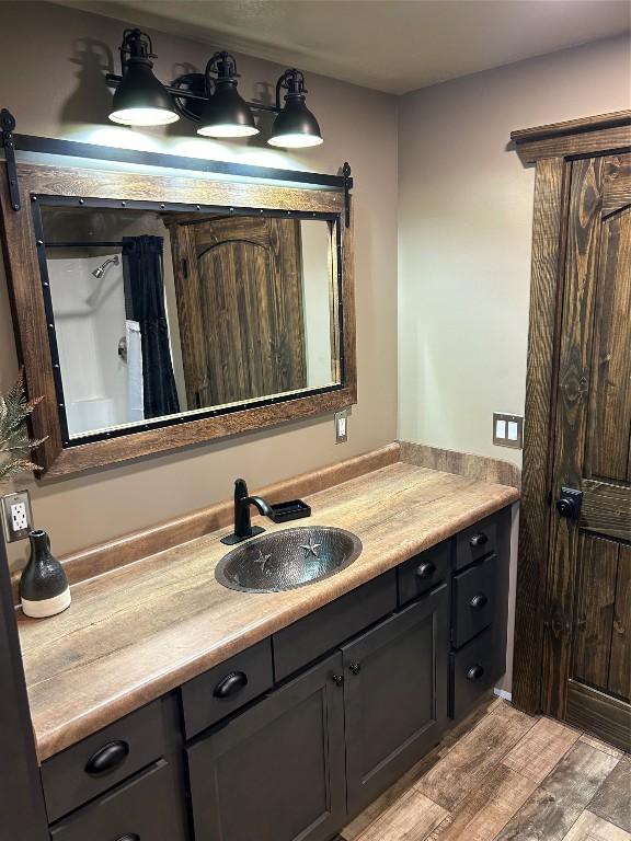 11667 Lakeland Dr, Conneaut Lake, PA 16316 - bathroom featuring vanity and wood finished floors